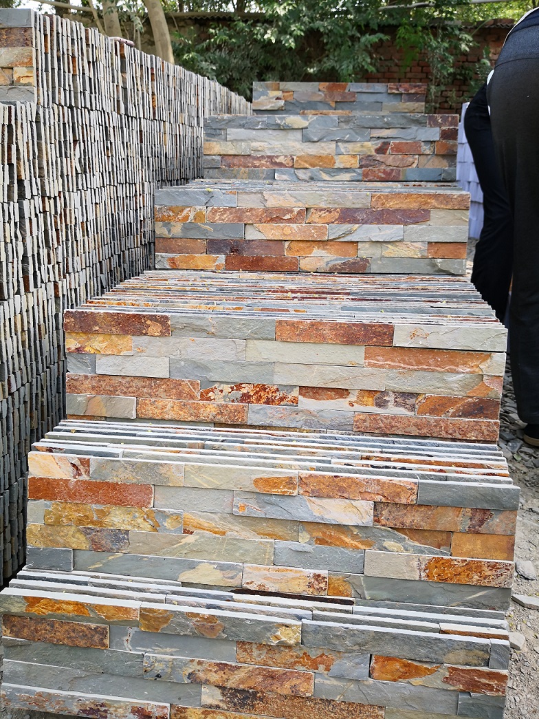 Close-up of natural rustic slate ledger stone showcasing textured surface and warm tones