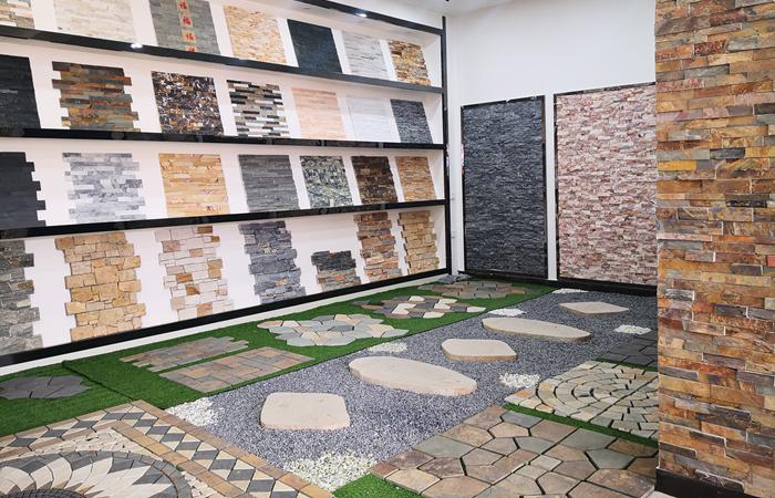 Interior view of a natural stacked stone showroom featuring various stone designs