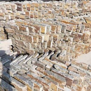 Corner piece for stone cladding, enhancing building aesthetics.