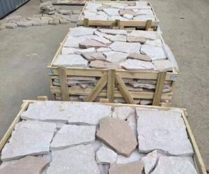A variety of irregular flagstone pavers in different shapes and natural colors.