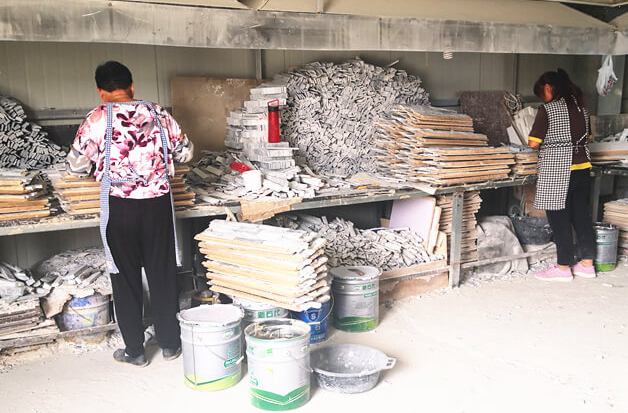 Skilled artisans assembling high-quality stacked stone panels