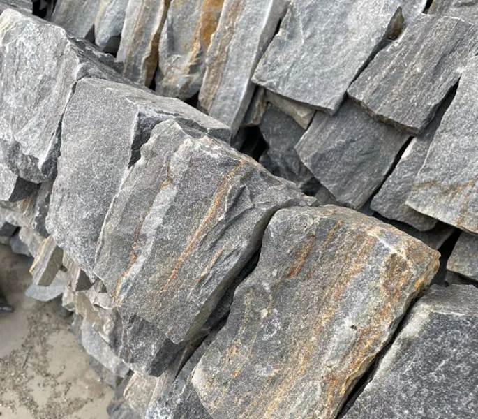 Decorative corner made from random loose stone for landscaping