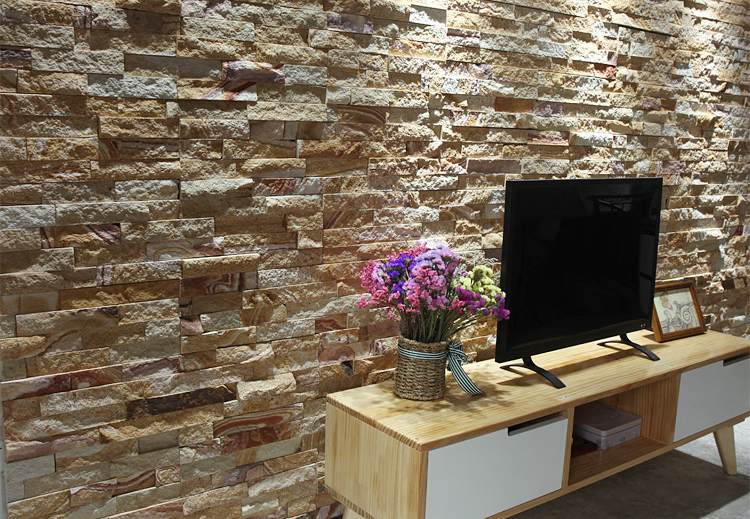 Stylish stacked stone accent wall featuring a TV setup