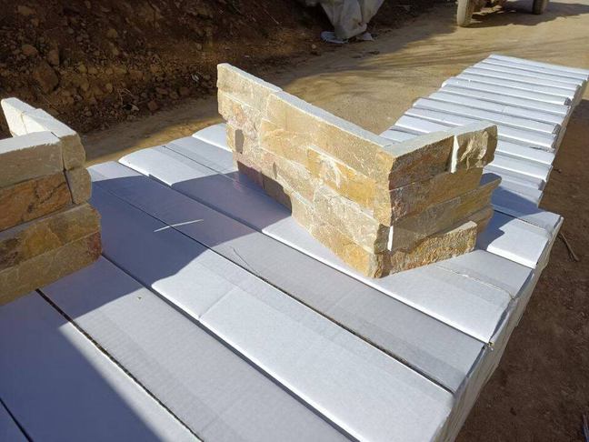 Corner view of elegant stacked stone wall featuring textured panels